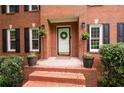 Detailed view of the brick steps leading to the front door, flanked by potted plants and charming accents at 4497 Windsor Oaks Dr, Marietta, GA 30066