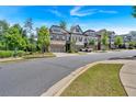 Street view of luxurious townhomes featuring well-maintained landscaping and convenient parking at 1099 Heyward Way, Alpharetta, GA 30009