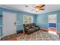 Comfortable living room with hardwood floors, a ceiling fan, and a cozy leather couch at 1770 Rockland Se Dr, Atlanta, GA 30316