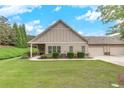 Inviting home exterior with a well-manicured lawn and a convenient three-car garage at 2384 Tree Arbor Way, Marietta, GA 30064