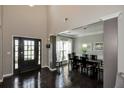 Elegant entryway boasting soaring ceilings, dark hardwood floors, and a view into the dining room at 2555 Blackstock Dr, Cumming, GA 30041