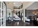 Grand foyer with dark hardwood floors, staircase with iron railing, and views to the living spaces at 2555 Blackstock Dr, Cumming, GA 30041
