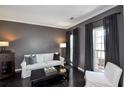 Cozy living room featuring dark hardwood floors, neutral walls, and ample natural light from large windows at 2555 Blackstock Dr, Cumming, GA 30041
