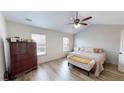 Bright bedroom with vaulted ceiling, wood-look floors, large windows and ample space for a relaxing retreat at 3325 Castleberry Village Cir, Cumming, GA 30040