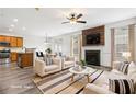 Open concept living room featuring modern furniture, neutral tones, and an eat-in kitchen area at 3325 Castleberry Village Cir, Cumming, GA 30040