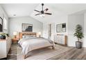 Bright main bedroom with a ceiling fan, hardwood floors, and white walls that accentuate natural light at 3325 Castleberry Village Cir, Cumming, GA 30040