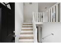 Bright entryway featuring a staircase with natural wood treads and white risers at 6322 Phillips Creek Dr, Lithonia, GA 30058