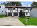 Charming two-story home with a well-maintained lawn and a two-car garage at 6322 Phillips Creek Dr, Lithonia, GA 30058