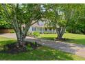 Charming home with mature trees, a long driveway, and a welcoming front porch, offering a serene setting at 2820 Channing Way, Cumming, GA 30040
