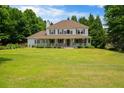 Beautiful two-story home with a spacious front lawn and a large, inviting porch perfect for relaxing at 2820 Channing Way, Cumming, GA 30040