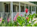 Inviting front porch with lush flowers in the foreground and a glimpse of the charming home in the background at 2820 Channing Way, Cumming, GA 30040
