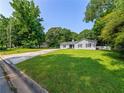 Traditional home with a large, lush front yard in a peaceful, tree-lined neighborhood at 30 Court S, Ellenwood, GA 30294