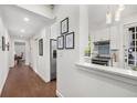 Hallway leading into kitchen area that features white walls, wood floors, and a marble counter at 124 Lafayette Ne Dr # 4, Atlanta, GA 30309