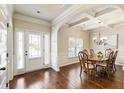 Elegant dining area with hardwood floors, coffered ceiling, and ample natural light at 1650 Walking Horse Trl, Cumming, GA 30041