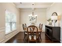 Cozy dining room with dark wood furniture, neutral walls and trimmed window at 1650 Walking Horse Trl, Cumming, GA 30041