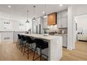 Bright kitchen features stainless appliances, a large island with seating, and hardwood flooring at 230 New St # 2201-4, Decatur, GA 30030