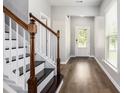 Inviting foyer with hardwood floors and staircase at 1295 Aster Ives Dr, Lawrenceville, GA 30045