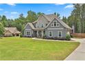 Beautiful two-story home with stone accents and a well-manicured lawn at 33 Vinery Ct, Sharpsburg, GA 30277
