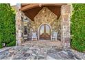 Stone facade entryway featuring a double door and rocking chairs at 2220 Peachtree Rd, Cumming, GA 30041