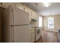 Classic kitchen with white appliances and plenty of cabinet space at 3984 Oak Glenn Dr, Duluth, GA 30096