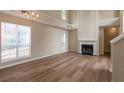Bright living room with hardwood floors, a fireplace, and large windows offering lots of natural light at 3984 Oak Glenn Dr, Duluth, GA 30096