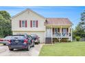 Charming two-story house features a covered front porch and driveway parking at 453 Villa Rosa Rd, Temple, GA 30179