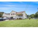 Charming two-story home with a cozy front porch, attached garage, and well-maintained lawn at 453 Villa Rosa Rd, Temple, GA 30179