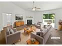 Bright, staged living room with fireplace and sliding glass doors to a deck at 6560 Alford Way, Lithonia, GA 30058
