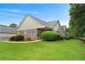 Beautiful home exterior featuring a lush green lawn and manicured shrubbery at 3734 Villa Springs Cir, Powder Springs, GA 30127