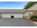 Attached two-car garage for convenient parking and storage, with a long driveway at 3734 Villa Springs Cir, Powder Springs, GA 30127