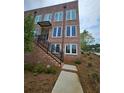 Brick townhouse with a private entrance, black railings, and professional landscaping at 401 Burton Dr, Alpharetta, GA 30009
