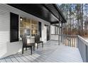 Inviting front porch with gray floor, white railing, and two chairs at 247 Mandy Ct, Mcdonough, GA 30252