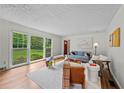 Bright living room featuring hardwood floors, large windows, and a comfortable seating arrangement at 3449 Parkview Dr, Atlanta, GA 30337