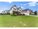 Beautiful two-story home featuring manicured landscaping and a welcoming three-car garage, offering curb appeal at 4105 Woodwind Dr, Cumming, GA 30028