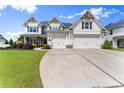 Beautiful two-story home featuring manicured landscaping and a welcoming three-car garage, offering curb appeal at 4105 Woodwind Dr, Cumming, GA 30028