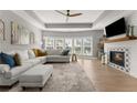 Bright living room with fireplace, neutral colors, and large windows overlooking the backyard at 4105 Woodwind Dr, Cumming, GA 30028