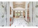 Grand foyer with marble floors, soaring ceilings, and elegant stairway at 115 Cross Roads Ct, Atlanta, GA 30327