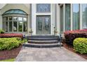 Elegant front entrance with stained glass double doors and stone walkway at 115 Cross Roads Ct, Atlanta, GA 30327