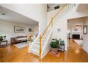 Bright foyer with wood floors and staircase leading to the second level of the home at 199 Eastham Ct, Suwanee, GA 30024