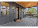 Inviting front porch featuring sleek gray panels, modern lighting fixtures, and a welcoming glass front door at 2497 Wawona Dr, Brookhaven, GA 30319