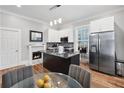 Modern kitchen with stainless steel appliances, an island, and a cozy dining area at 50 Ormond Sw St, Atlanta, GA 30315