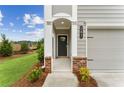 Front entrance featuring brickwork, white pillars and trim, and a landscaped yard at 101 Priestwood Ln, Acworth, GA 30102