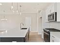 Stylish kitchen with an island, white countertop and cabinets, and stainless steel appliances at 101 Priestwood Ln, Acworth, GA 30102