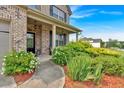 Well-manicured front yard with lush greenery and a charming walkway leading to the front door at 2239 Noelle Pl, Powder Springs, GA 30127