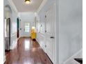 Inviting hallway with hardwood floors, white trim, and arched doorways at 2239 Noelle Pl, Powder Springs, GA 30127