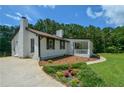 Side view of home with manicured landscaping and driveway at 871 Cowan Se Rd, Conyers, GA 30094