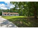 Expansive yard with mature trees offering shade and tranquility at 871 Cowan Se Rd, Conyers, GA 30094