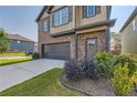 Charming two-story home with a well-kept lawn, featuring a two-car garage and landscaped shrubbery at 11910 Brightside Pkwy, Hampton, GA 30228