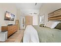 Comfortable main bedroom featuring vaulted ceilings, wood floors, neutral colors, and an ensuite at 1865 Morgans Run Trl, Buford, GA 30519