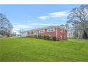 Well-maintained red brick home with attached garage and lush green yard at 2649 Lake Harbin Rd, Morrow, GA 30260